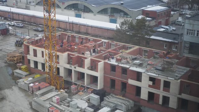 The construction of multi-storey houses of brick, the builders working all day. 4k. 3840x2160. time laps