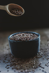 Bowl full of brown flaxseed or linseed. Cereals. Vitamins. Healthy food.