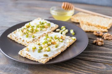 Light sandwiches slathered with cream cheese, sprouts beans, gluten-free