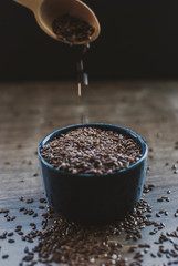 Bowl full of brown flaxseed or linseed. Cereals. Vitamins. Healthy food.
