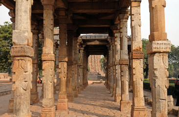 Columns with stone carving in courtyard of Quwwat-Ul-Islam mosque, Qutab Minar complex, Delhi, India 