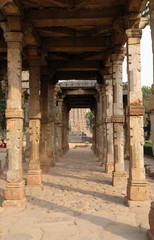 Columns with stone carving in courtyard of Quwwat-Ul-Islam mosque, Qutab Minar complex, Delhi, India 