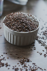 Bowl full of brown flaxseed or linseed. Cereals. Vitamins. Healthy food.