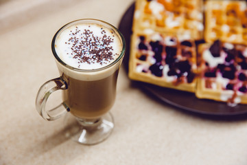 Breakfast in the kitchen. Coffee and Wafers with chocolate, cloudberries, blueberries and ice cream.