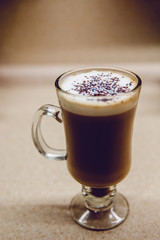 Coffee in the kitchen. We prepare coffee at home with our own hands. With caramel and colored powder.