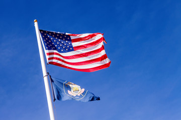 american flag waving in the blue sky, the stars and stripes with white pole