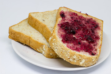 bread with spread jam on the  dish on white  isolate background