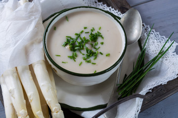 Spring season - homemade white  asparagus soup with fresh green chives ready to eat