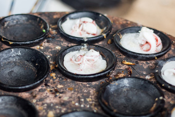 Tentacles octopus fried in cast-iron cups