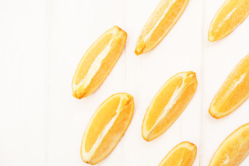 Slices of orange on a wooden white background