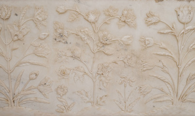 Mughal stone art on the facade of the Taj Mahal (Crown of Palaces), an ivory-white marble mausoleum...