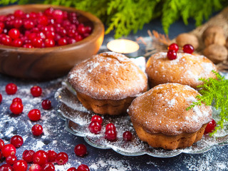 Fresh homemade muffins baking with berries cranberries on a blue background, cozy festive style