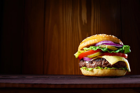 Big hamburger on wooden background