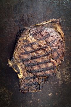 Barbecue dry aged Cote de Boeuf as close-up on a rusty metal sheet