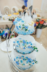 Beautiful three-tiered wedding cake in blue on the wedding Banquet