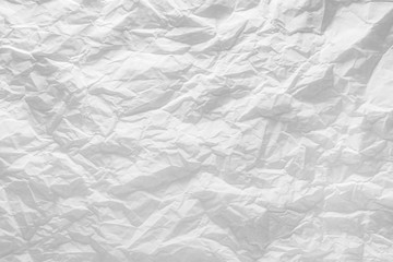 Surface of crumpled paper highlighted by light.
Stressed, illuminated sheet of paper paper.