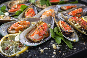 Baked Green Shell Mussels as close-up on old rustic sheet