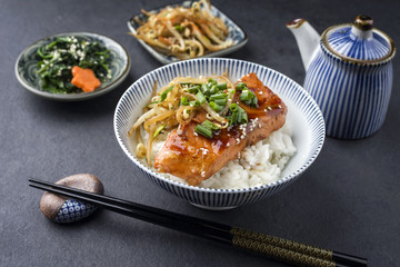 Traditional Japanese Salmon Teriyaki with Rice and Vegetable as close-up in a bowl
