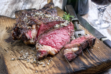 Barbecue dry aged Wagyu Tomahawk Steak as close-up on a cutting board