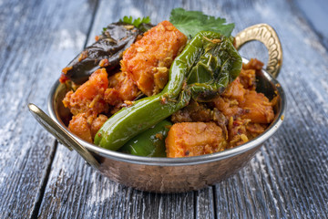 Indian Vegetable Curry Fry with Sweet Potatos and Eggplant as close-up in a Kadai