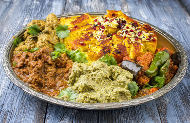 Traditional Indian Iranian Curries as close-up on a Thali