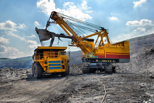 Loading of iron ore on very big dump-body truck