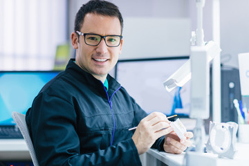 Prosthetic dentistry technician working in his office