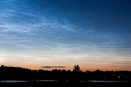 Noctilucent clouds at night sky