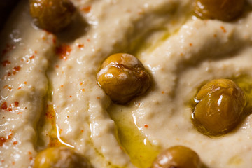 Homemade Chickpea Hummus in Rustic Bowl with Olive Oil and Fresh Pita Bread