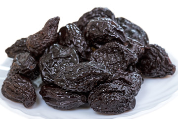 Pile of prunes on white