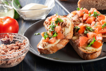 Appetizer bruschetta with tuna, mozarella cheese and tomatoes