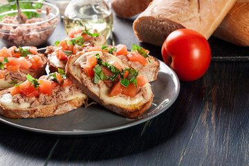 Appetizer bruschetta with tuna, mozarella cheese and tomatoes