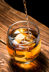 whiskey with ice on a wooden table
