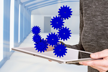Woman holding tablet pc with gears