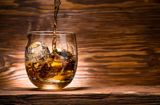 whiskey with ice on a wooden table