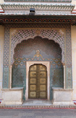 Fototapeta na wymiar Ornate door at the Chandra Mahal, Jaipur City Palace in Jaipur, Rajasthan, India