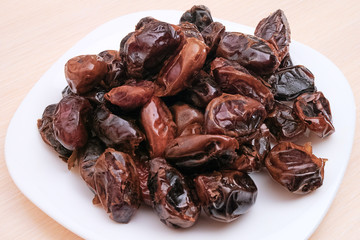 Pile of dates on a white plate