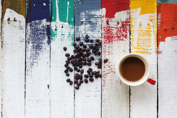 coffee cup with coffee bean on colorful wooden panel
