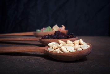 Fototapeta na wymiar Peanuts, raisins and candied fruits - healthy breakfast