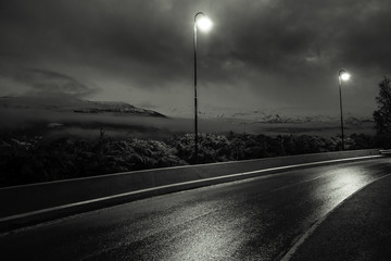 street lamp and a view on the mountains in black and white