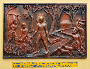 Lord being, harrassed in non-aryans country, Street bass relief on the wall of Jain Temple in...