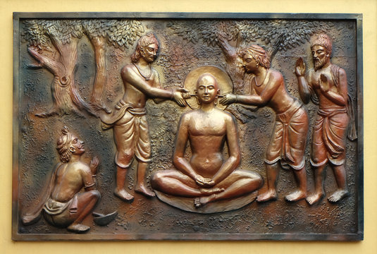 The pegs are being extracted with the help incers, Street bass relief on the wall of Jain Temple in Kolkata