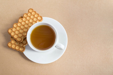 White cup of tea with biscuits