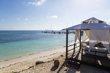 Terrace on the beach. Turquoise water of the Caribbean sea on the background. Relaxing vacation concept image.