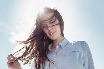 Spring or summer portrait of a beautiful young woman smiling happy student outdoor