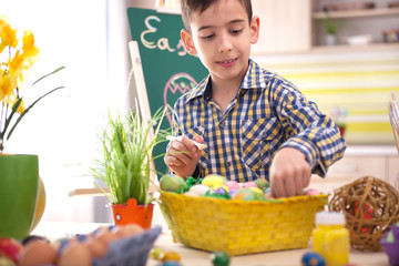 young boy playing with easter eggs