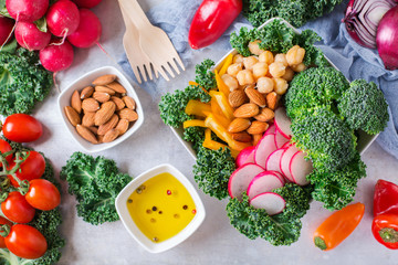 Healthy vegan buddha bowl with kale leaves and raw vegetables
