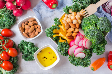 Healthy vegan buddha bowl with kale leaves and raw vegetables