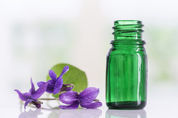 Fototapeta na wymiar Raw materials for essential oils, organic cosmetics. Flowers with glasss bottle