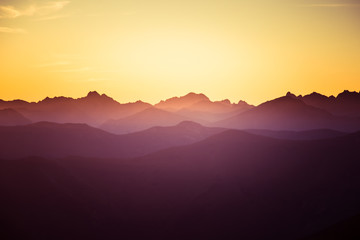 Obraz premium A beautiful, colorful, abstract mountain landscape in a mystic purple and orange tonality. Decorative, artistic look.